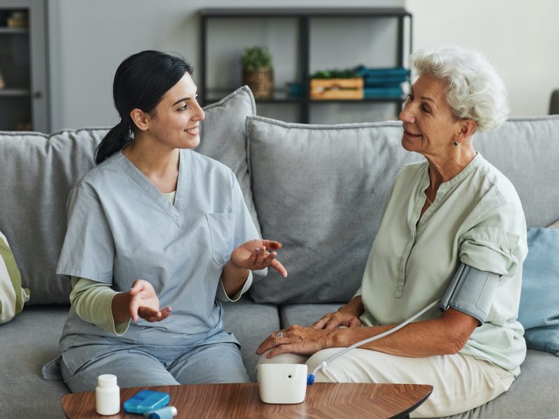 young-nurse-talking-to-senior-woman-in-retirement-home.jpg